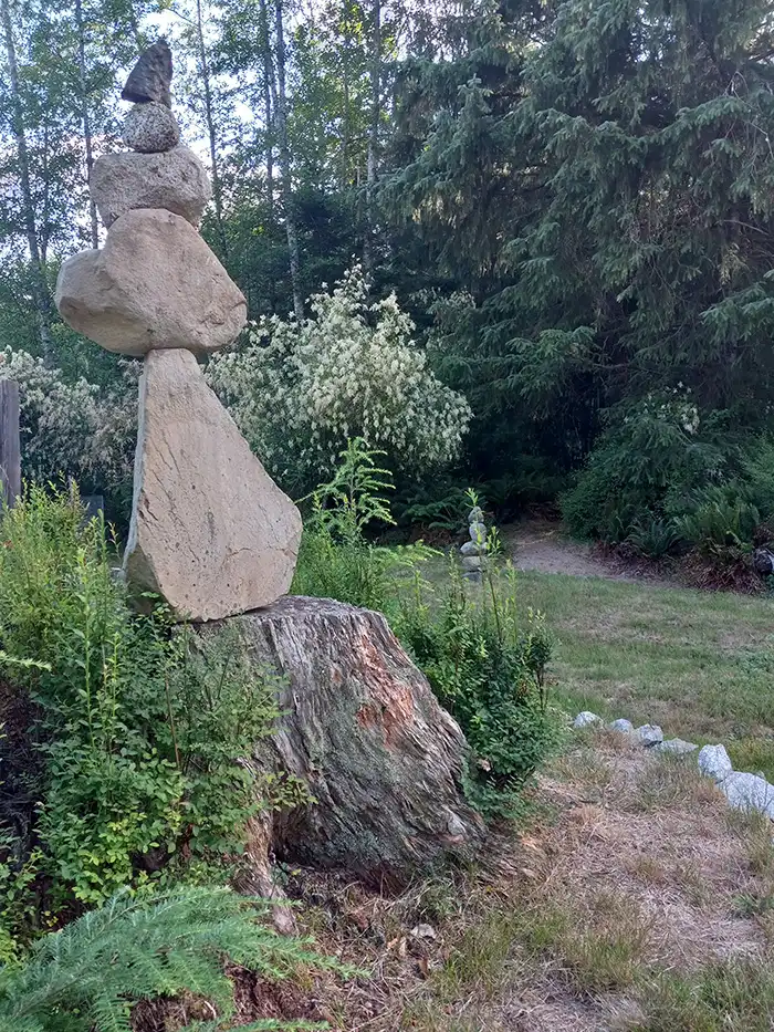 A photo of rocks stacked improbably balance, on the grounds of Chez Claire